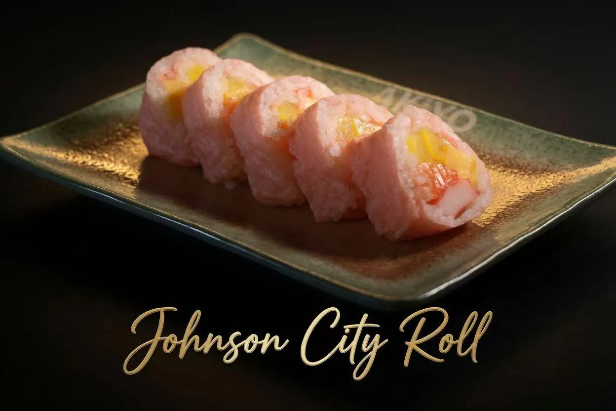 Five pieces of pink Johnson City specialty sushi roll filled with mango and crab on rustic glazed rectangular plate at Akiyo, a Japanese Restaurant in Johnson City