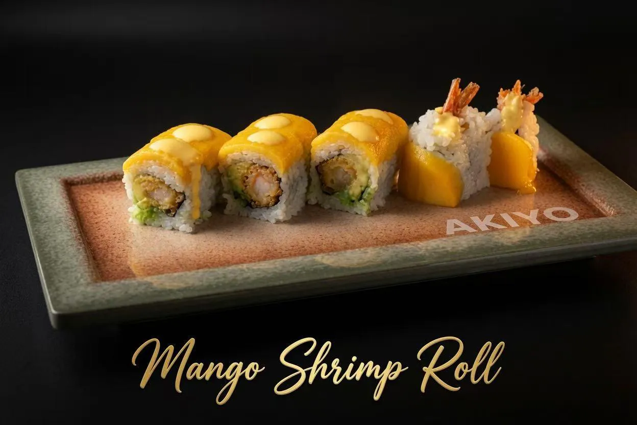 Mango shrimp sushi roll with tempura shrimp, fresh mango and creamy sauce on branded ceramic plate with gold name text at Akiyo, a Japanese Restaurant in Johnson City